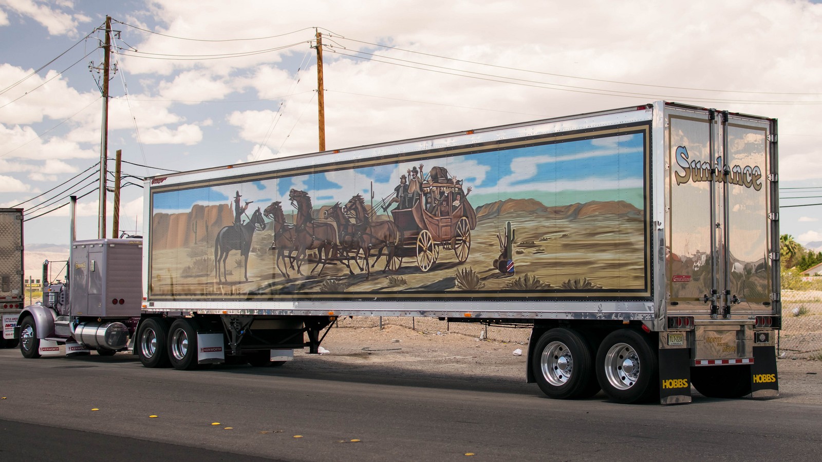 Araf truck with a painting of a stagecoach on the side of it (trailer truck, truck, kenworth, tractor unit, transport)