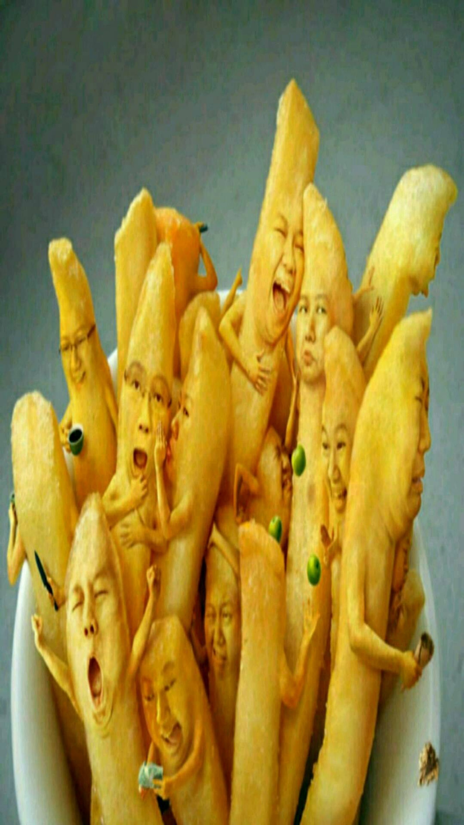 Arafed bowl of french fries with faces and peas (faces, funny fries)