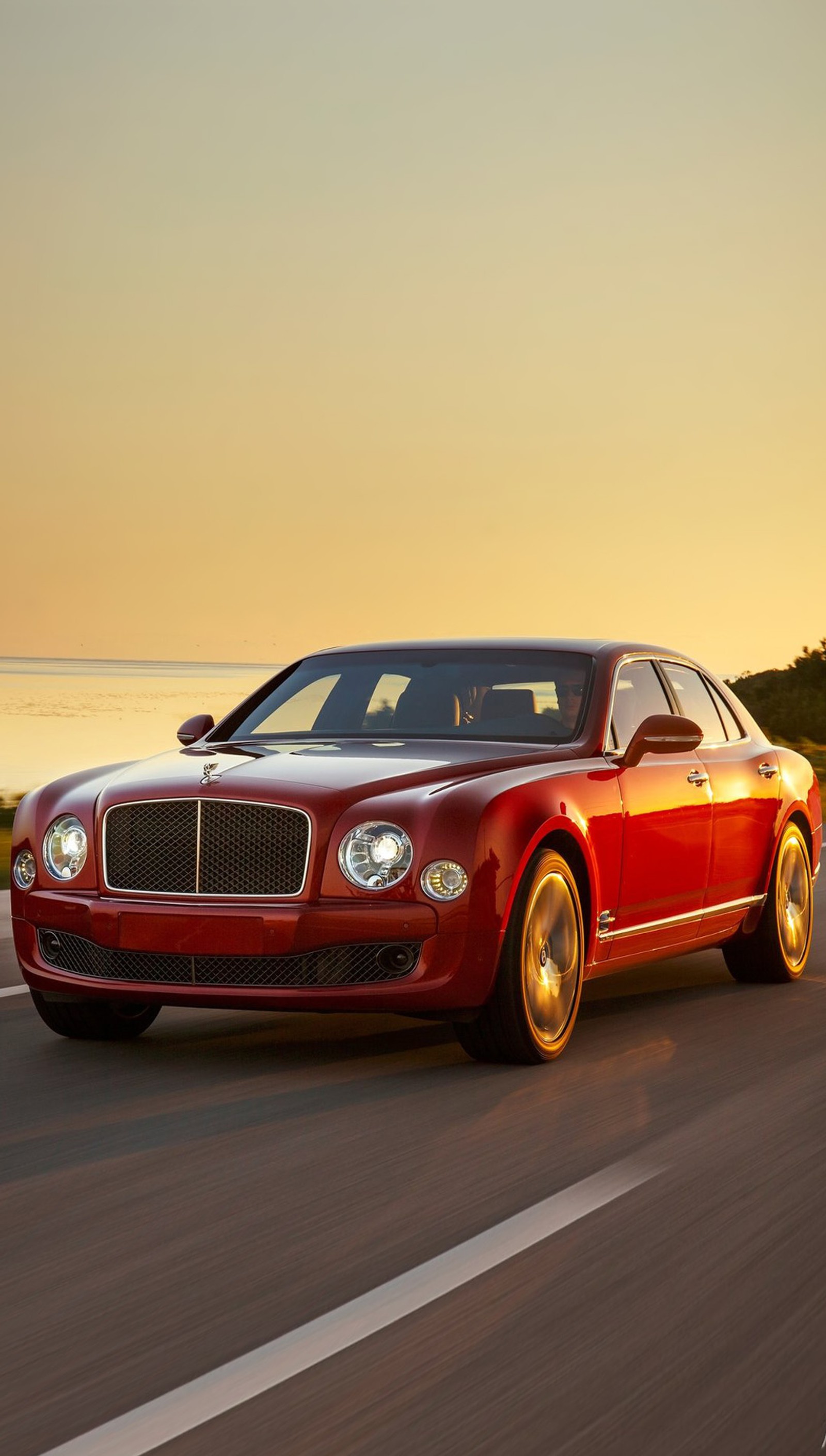 A close up of a red bentley car driving on a road (bentley, mulsanne)