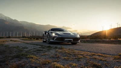 Ferrari F8 Tributo em um cenário de pôr do sol pitoresco, exibindo seu design elegante contra um fundo de montanhas e turbinas eólicas.