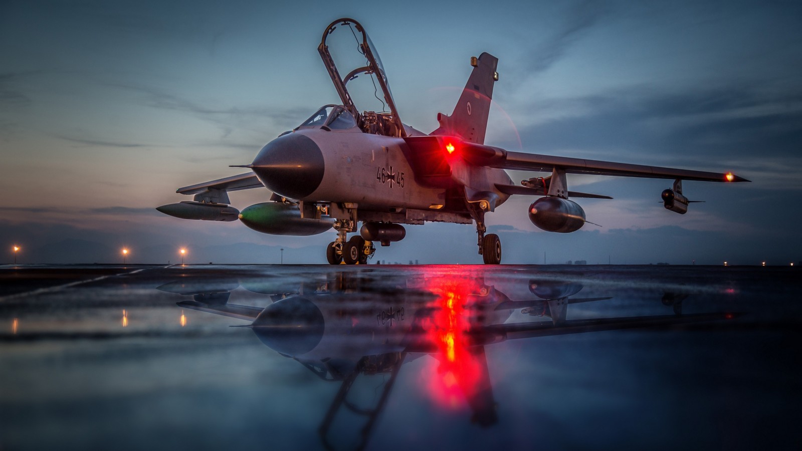 Arafed jet on runway with red lights at dusk (panavia tornado, military aircraft, airplane, aircraft, aviation)