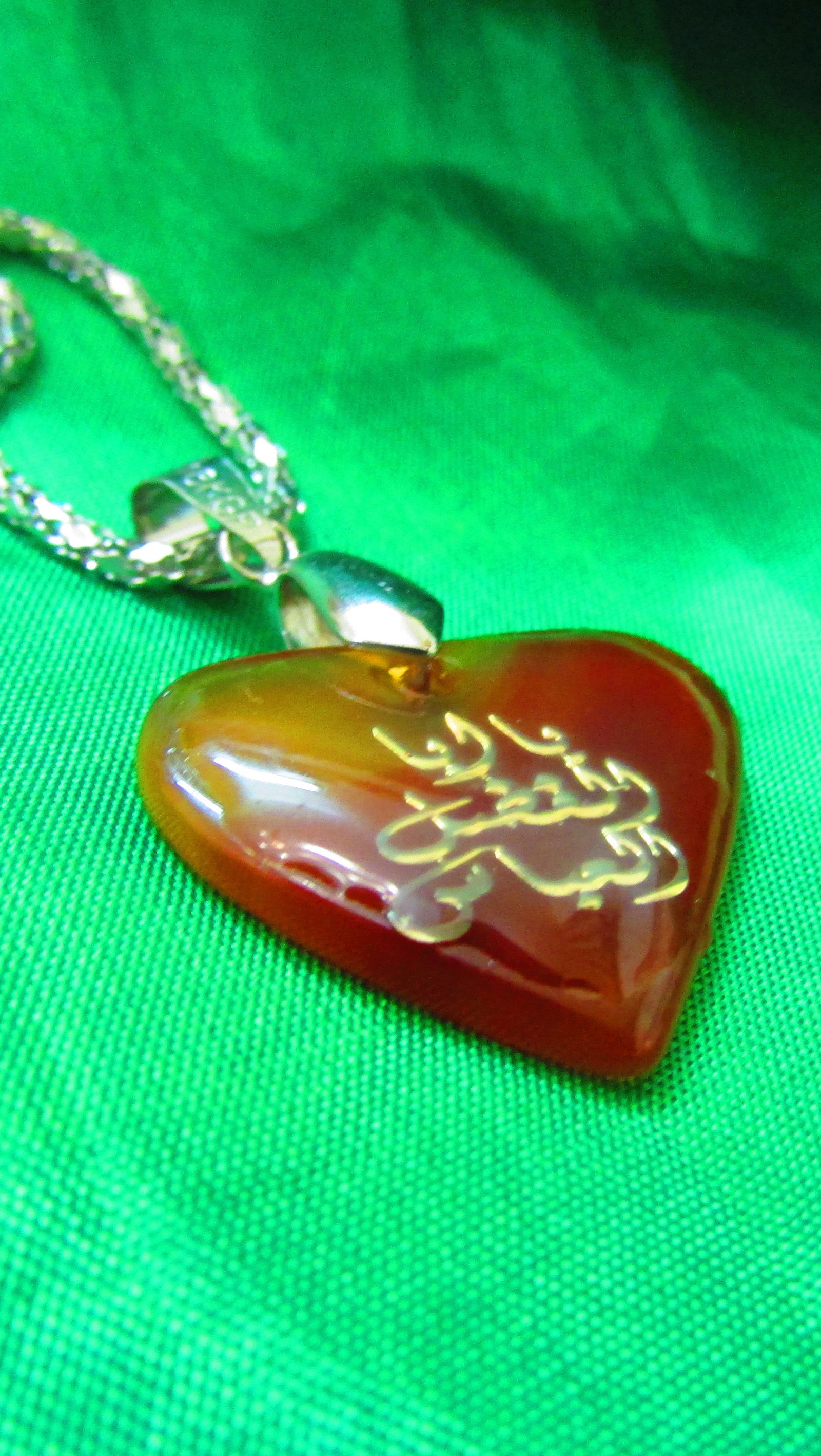 There is a heart shaped pendant with a message on it (abbas, arab, arabs, islam, love)