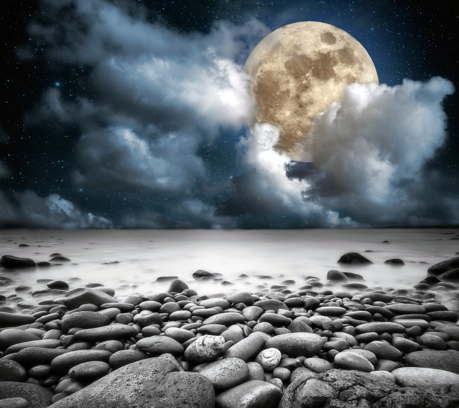 A large full moon is shining over a rocky beach (beach, full, moon, moonlight, night)