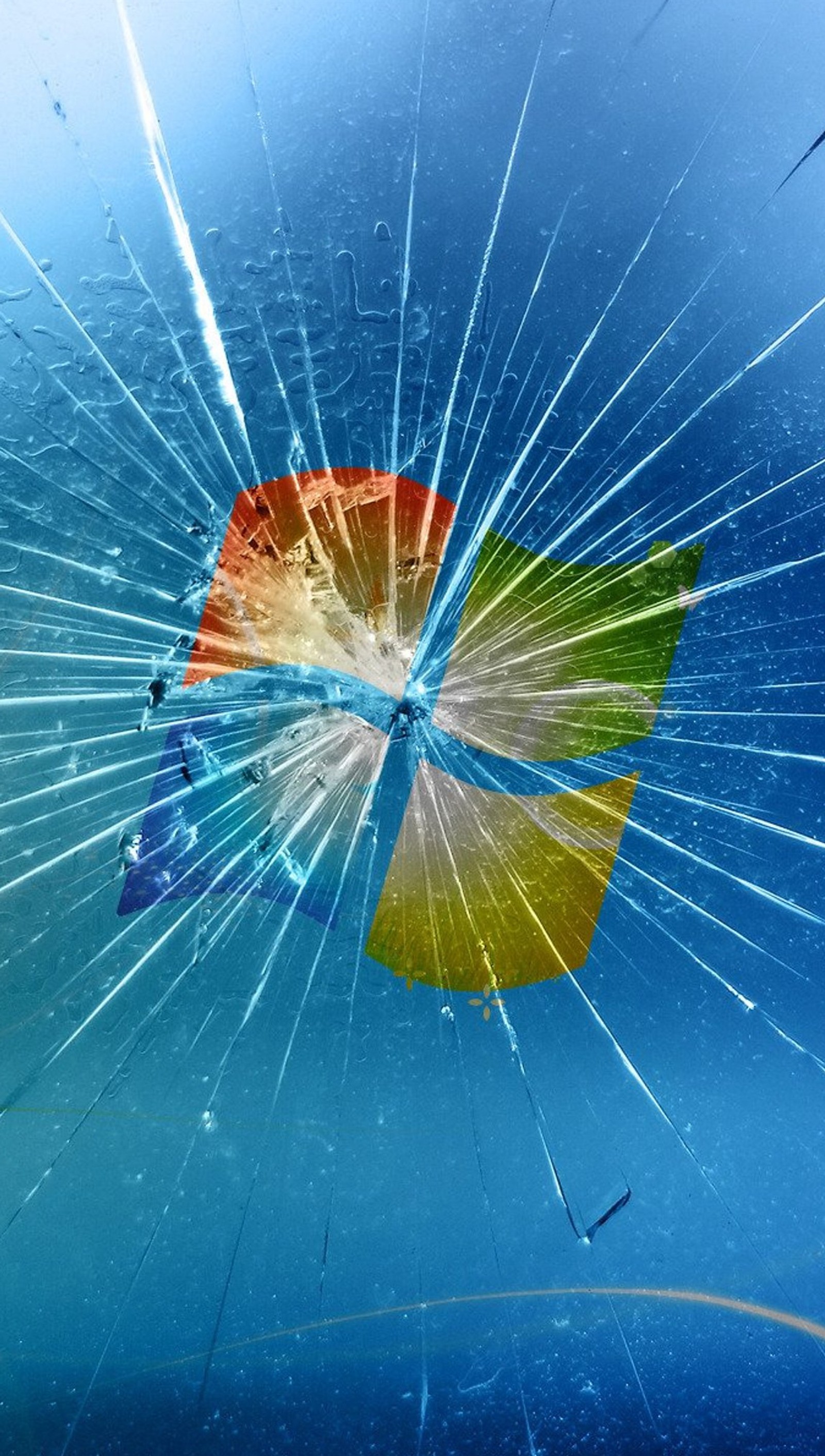 A close up of a broken window with a rainbow colored window pane (crack, desktop, window)