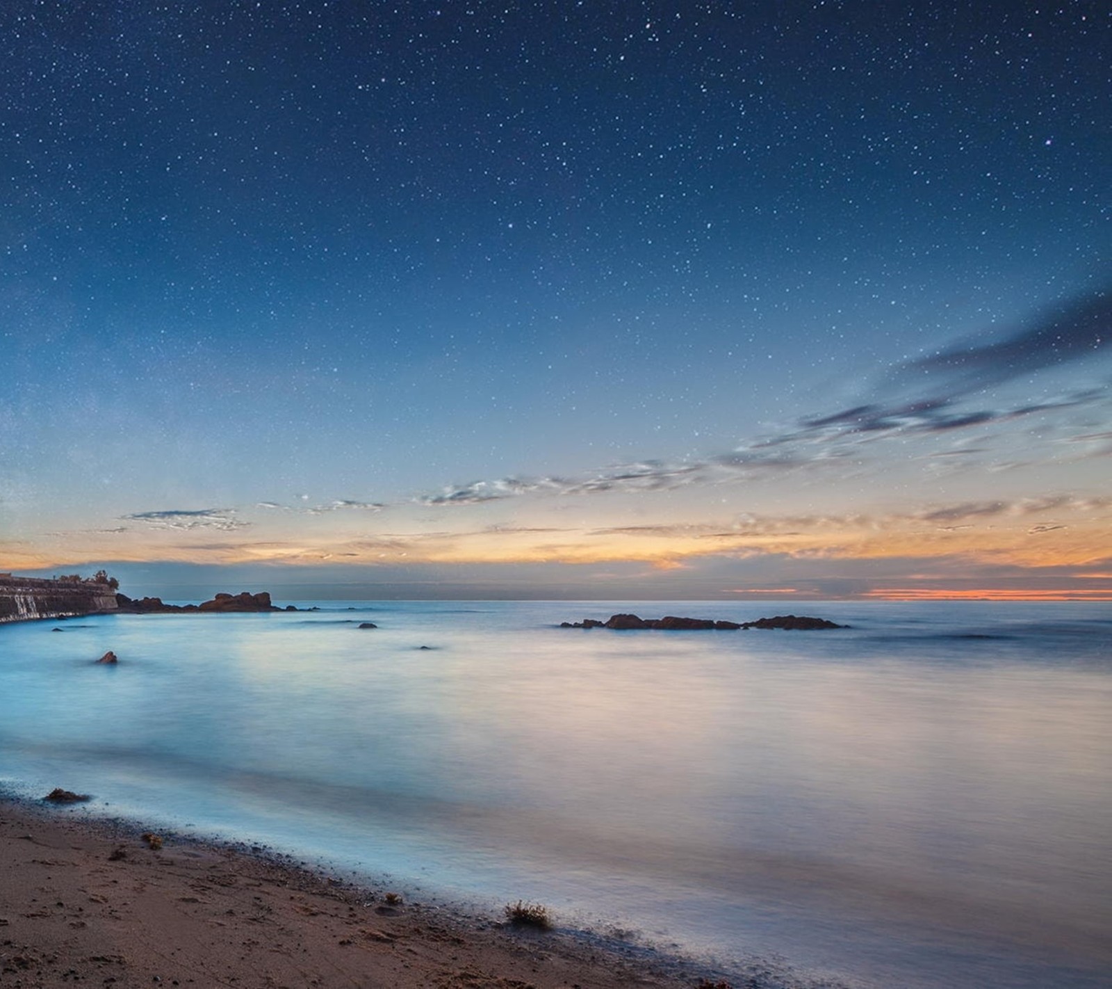 Night sky over the ocean with a lighthouse and a beach (landscape, nature)