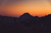 Majestic Mountain Sunset Over Tranquil Horizon