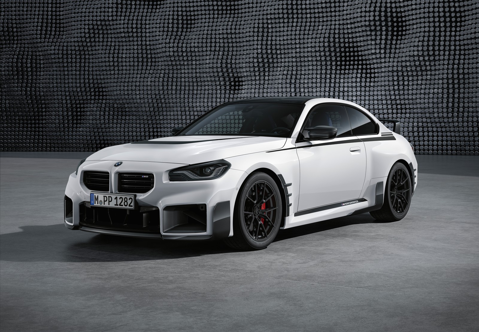 A white bmw car parked in front of a wall with a black background (bmw m2 m performance parts, 2023, 5k, 8k, cars)