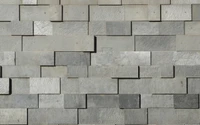 Pared de piedra gris texturizada con patrones de azulejos variados