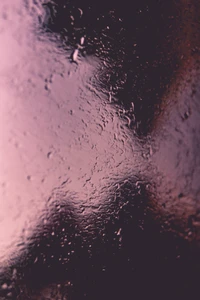 Close-Up of Moisture on Glass with Soft Pink and Blue Reflections