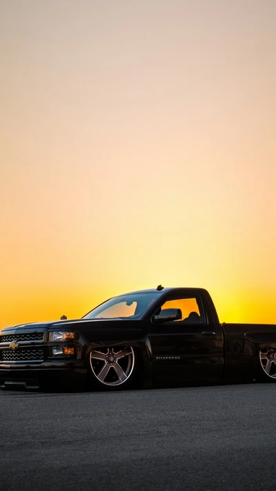 Sleek Black Chevrolet Silverado: A Tuned Truck Embracing Speed at Sunset