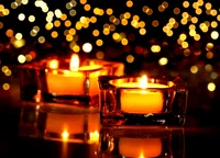 Warm Glow of Tealight Candles Amidst a Sea of Shimmering Lights