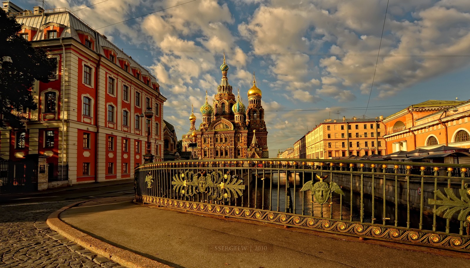 Arafed view of a city street with a bridge and a church (church of the savior on blood, landmark, city, town, building)