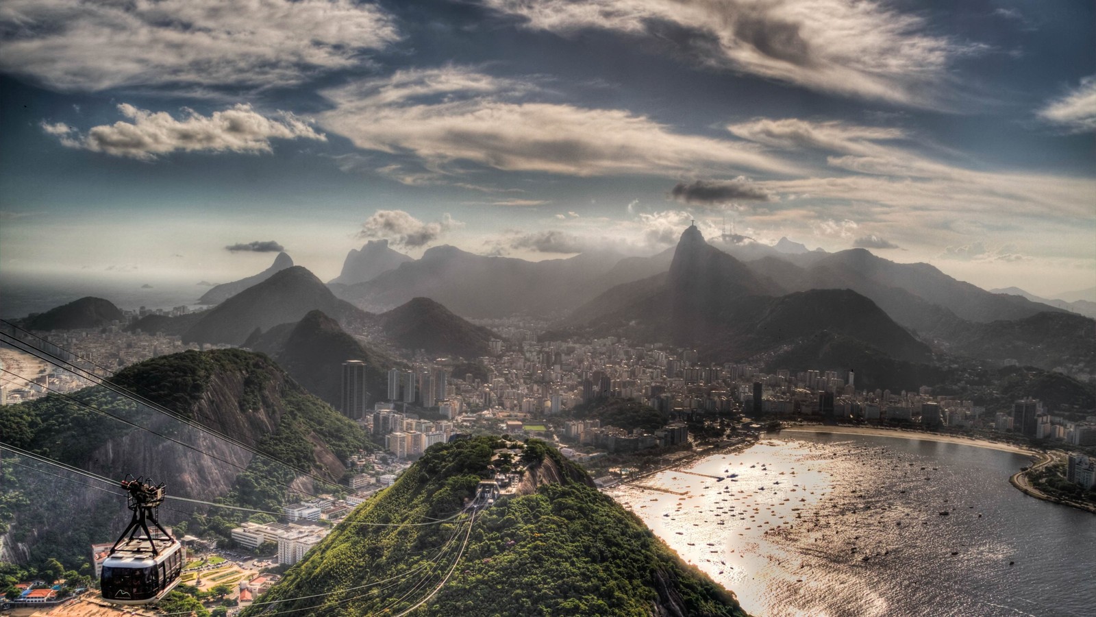 A view of a city with a mountain in the background (copacabana beach, mountainous landforms, mountain, highland, mountain range)