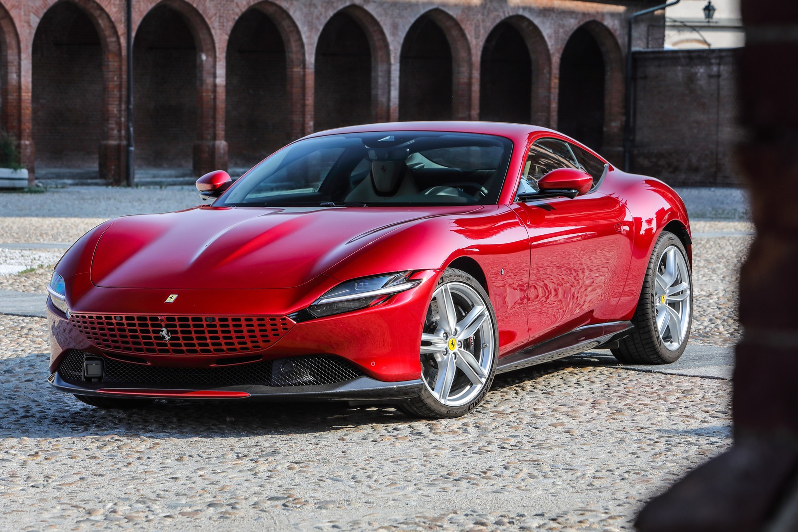 A red ferrari sports car parked in front of a brick building (ferrari roma, 2021, sports cars, 5k, cars)