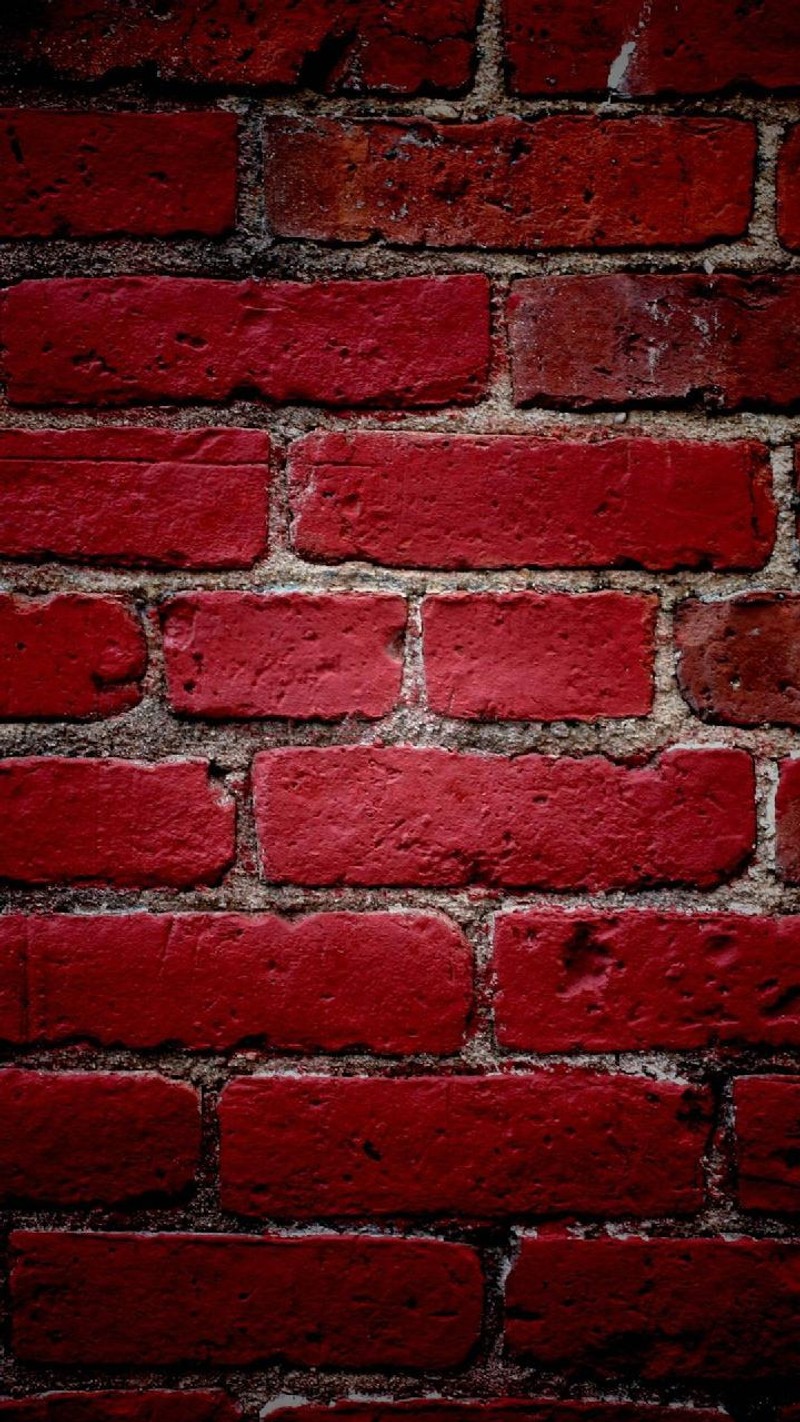 A close up of a red brick wall with a black background (loyalty, pared)