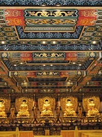 Majestic Golden Statues in a Vibrantly Decorated Temple