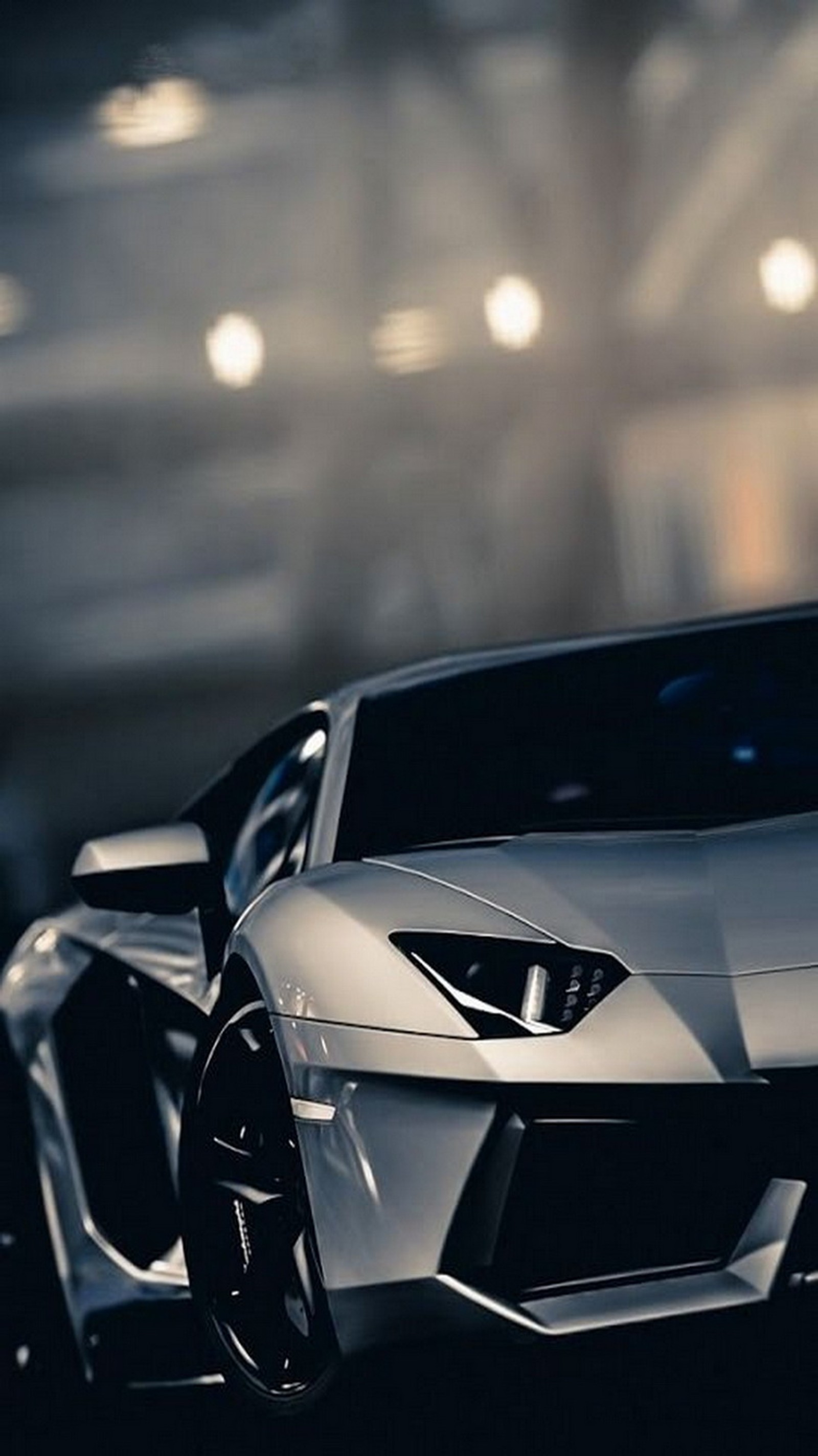 A close up of a silver sports car parked in a parking garage (aventador, lamborghini, silver)