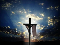 Silhouette of a Cross Against a Dramatic Sky