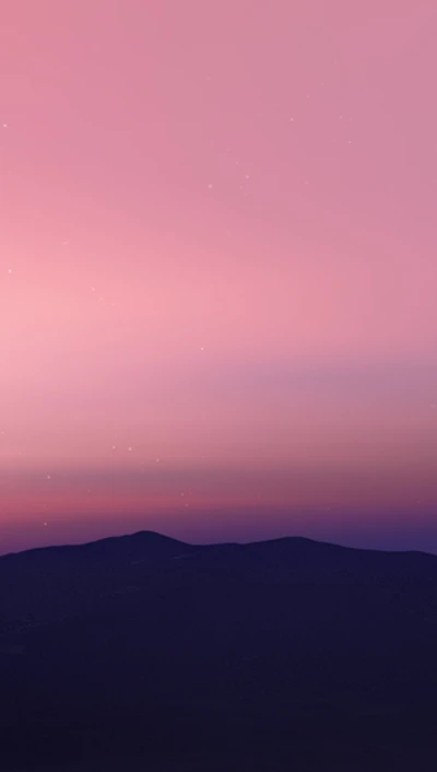 Montanhas serenas sob um suave céu rosa