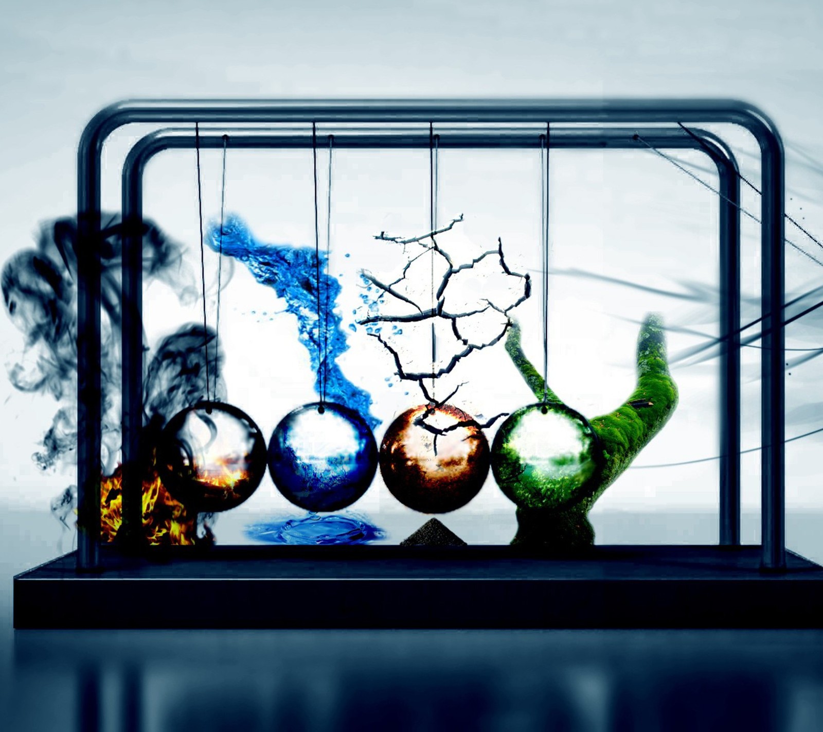 There are three glass balls in a glass case with a blue background (earth, elements, fire, water)