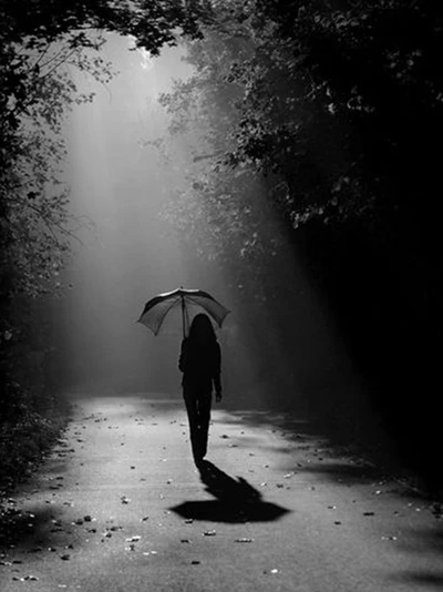 Lonely Girl Walking in the Dark with an Umbrella