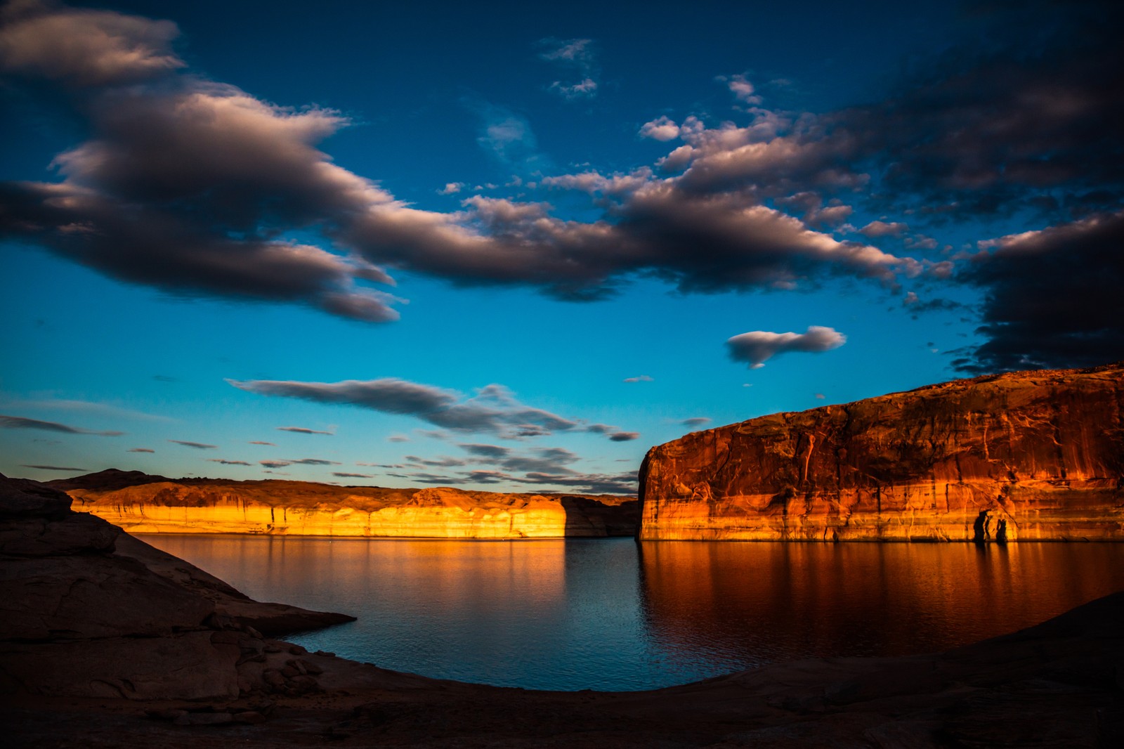 A view of a lake with a cliff in the background (nature, cloud, water, blue, reflection)