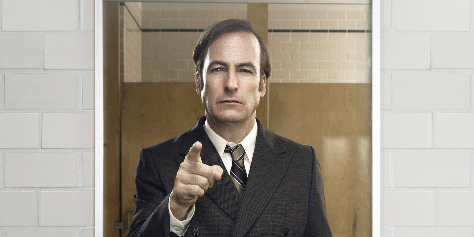 There is a man in a suit pointing at the camera (better call saul, saul goodman, amc, suit, businessperson)