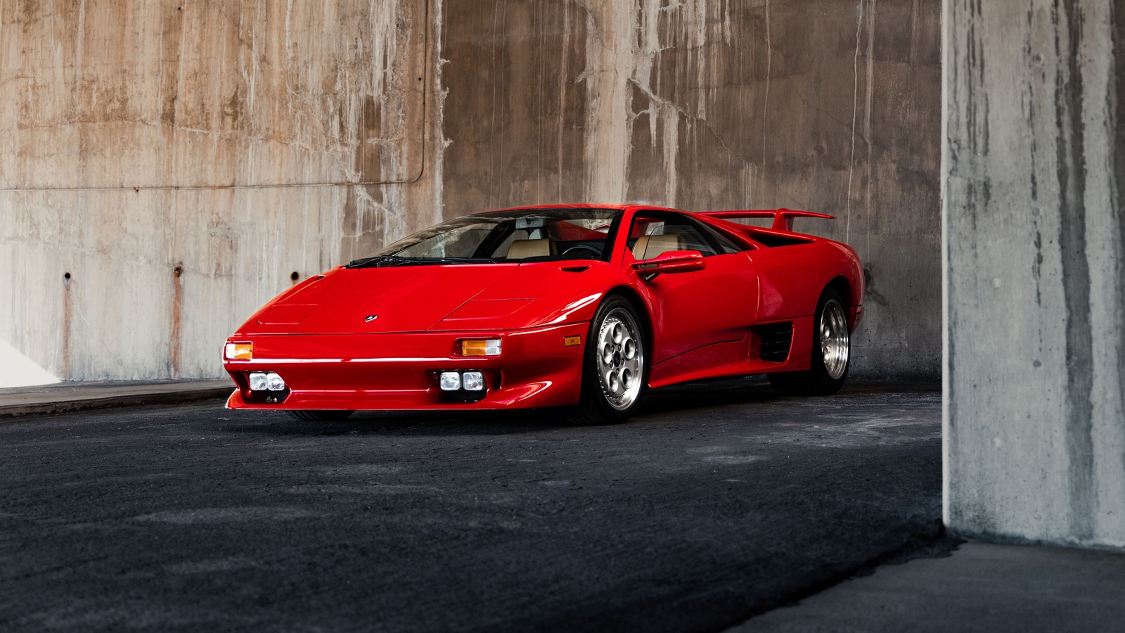 Arafed red sports car parked in a parking garage (lamborghini diablo vt, sports cars, red cars, classic cars, cars)