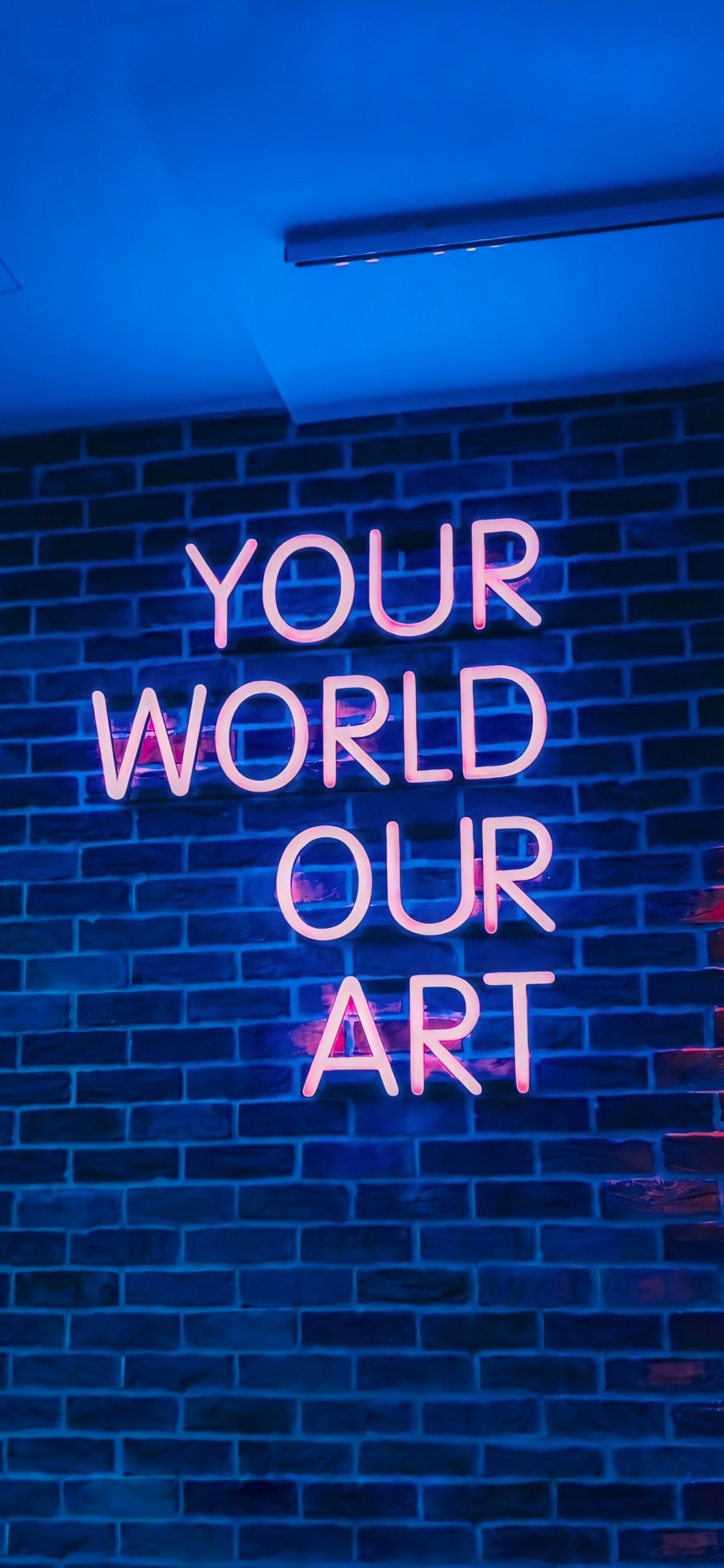 Neon sign on brick wall with words that read your world our art (neon sign, electronic device, night, entertainment, blue)