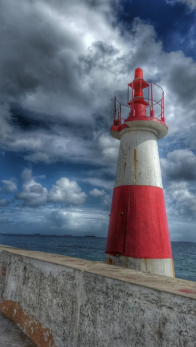 Lebhafter Leuchtturm gegen einen dramatischen Himmel