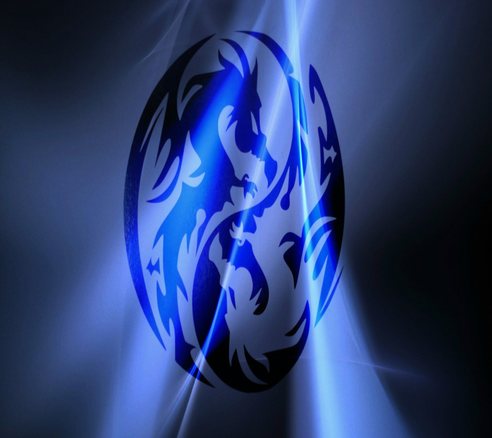 A close up of a blue and black dragon logo on a black background (dragon, wallpaper)