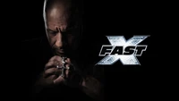 Vin Diesel in a contemplative pose, holding a cross necklace, with the "Fast X" logo prominently displayed.