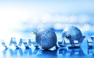 Sparkling Blue Christmas Ornaments on a Shimmering Surface