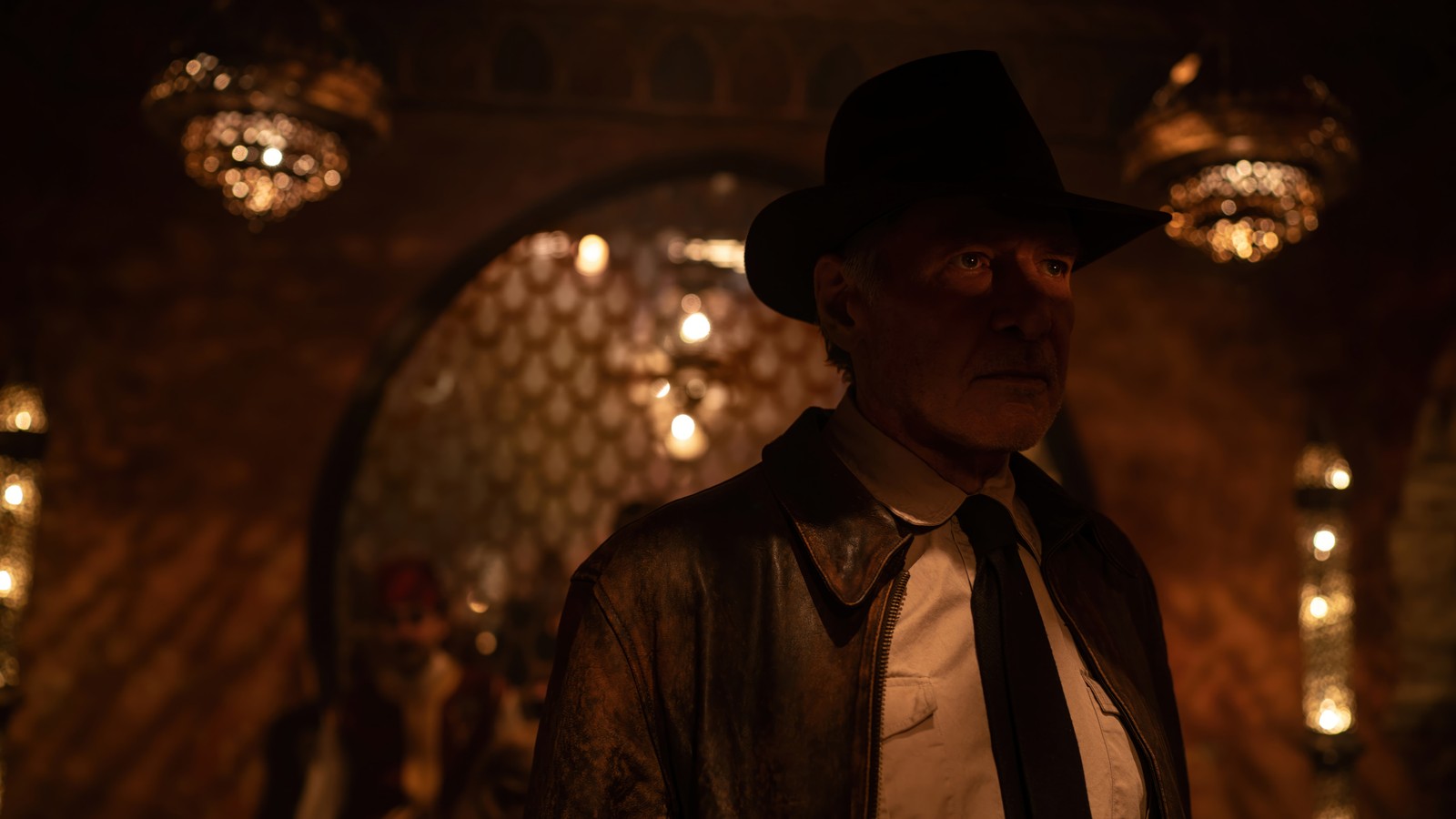 Arafed man in a hat and tie standing in a dimly lit room (indiana jones and the dial of destiny, movie, 2023, harrison ford)