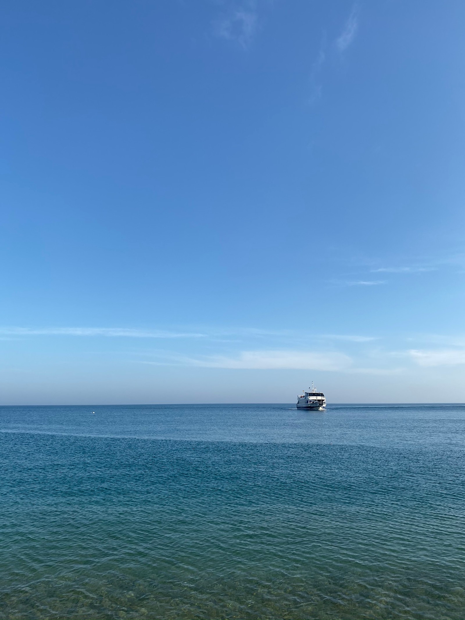 There is a boat that is out in the water on a clear day (sea, daytime, fluid, watercraft, liquid)