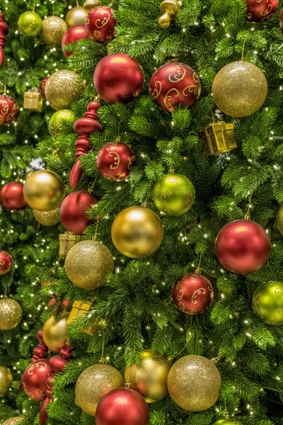 Festively adorned Christmas tree with vibrant red, gold, and green ornaments, capturing the spirit of the holiday season.