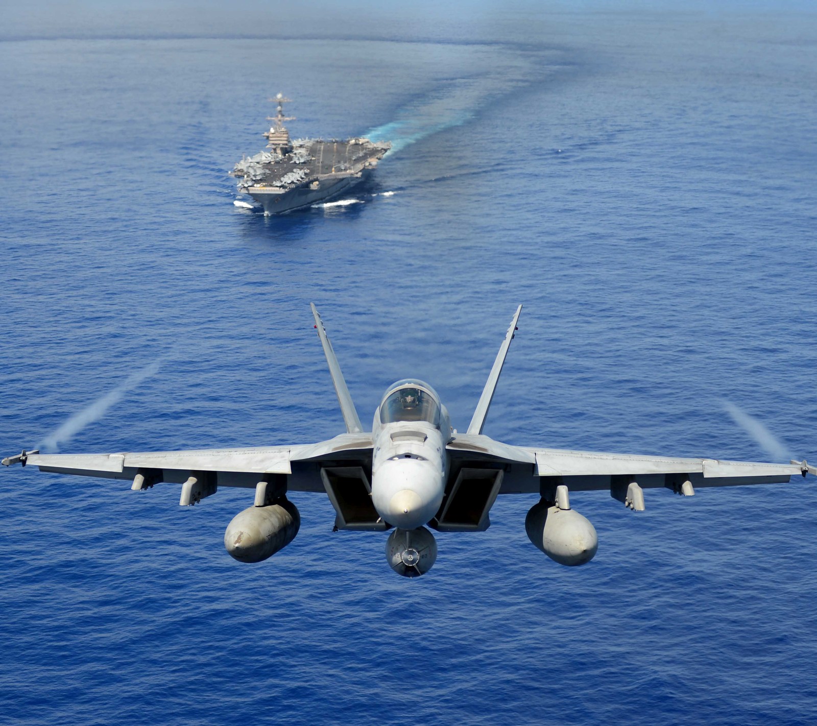 Araflane jet flying over the ocean with a ship in the background (navy, ocean, strength, usa, zedgemilitary)