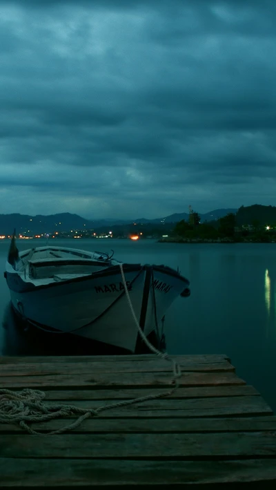 Serene Night at the Dock with a Blue Boat