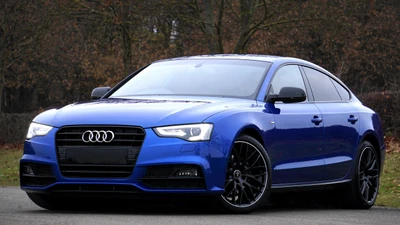 Sleek blue Audi A5 featuring a stylish design and premium rims, embodying personal luxury and performance.