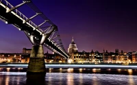 Illuminated Millennium Bridge with St Paul's Cathedral at Night Over the River Thames