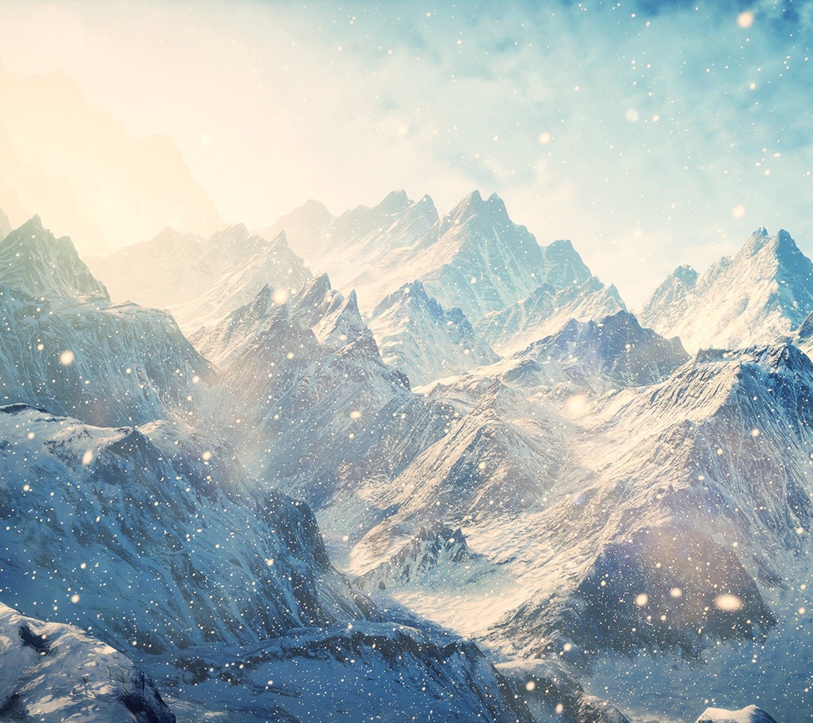 Snowy mountain range with snow falling down and a blue sky (mountain, snow)