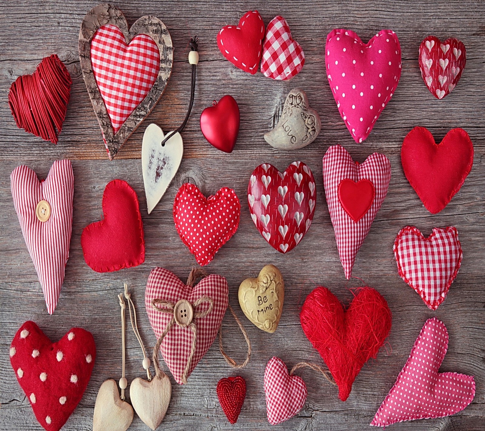 A close up of a bunch of different shaped hearts on a table (heart, love, valentine, wood)