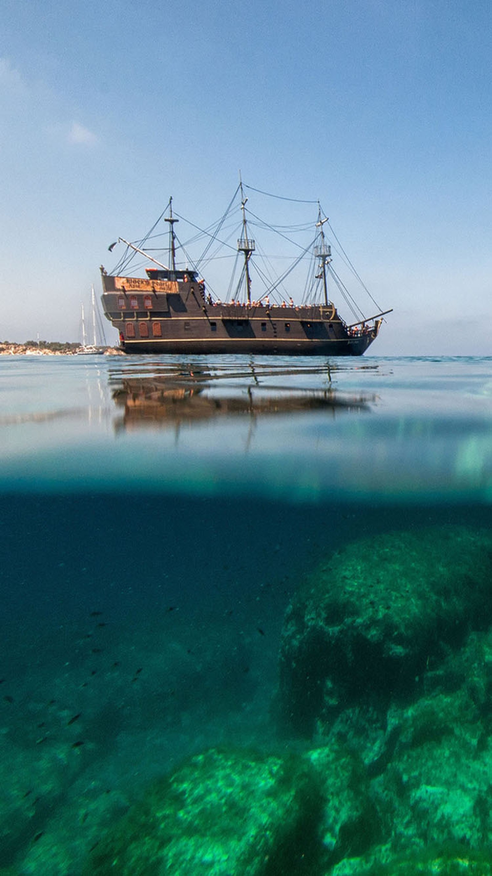 Há um barco flutuando na água (barco, mar)