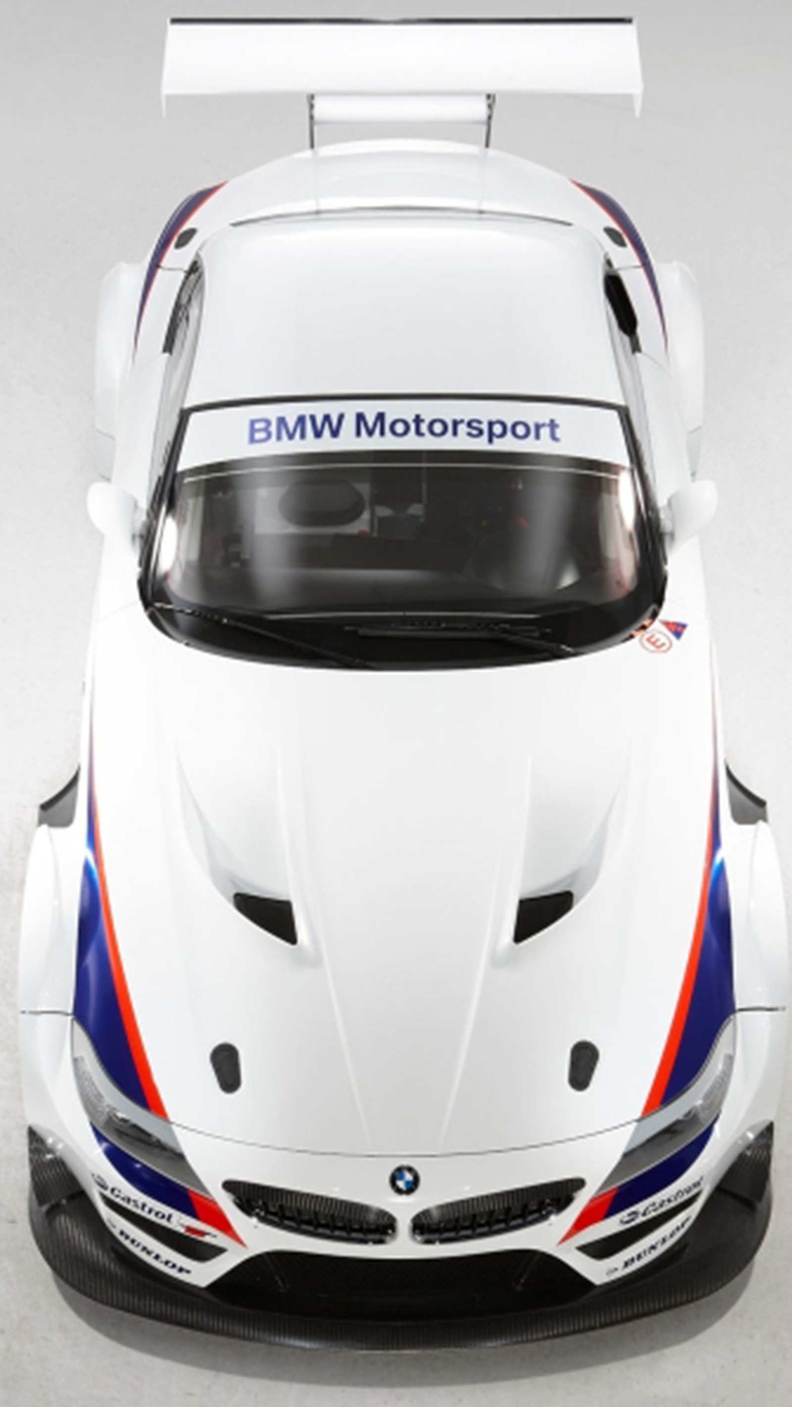 A close up of a white bmw sports car with blue and red stripes (bmw, car, nice)