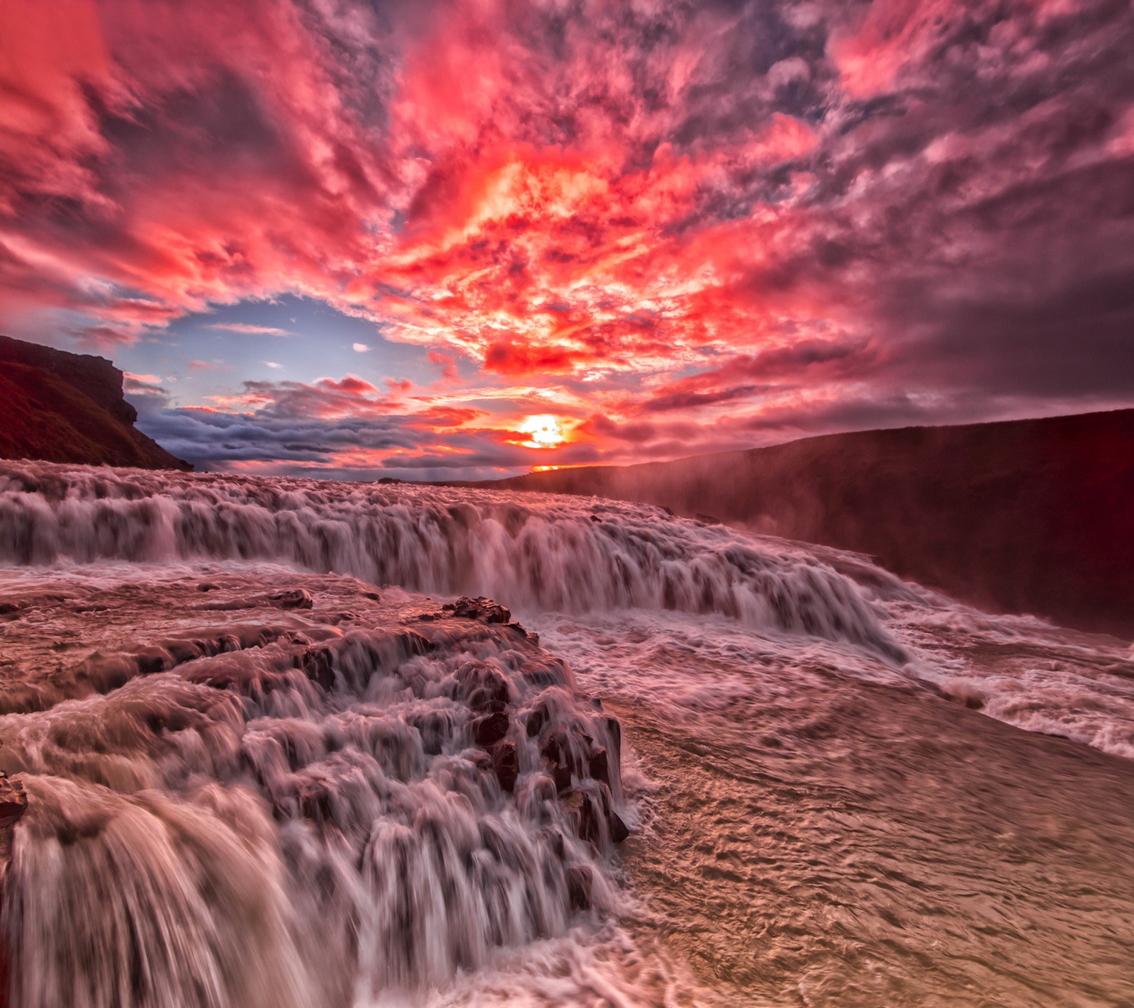 A close up of a waterfall with a sunset in the background (beautiful, landscape)