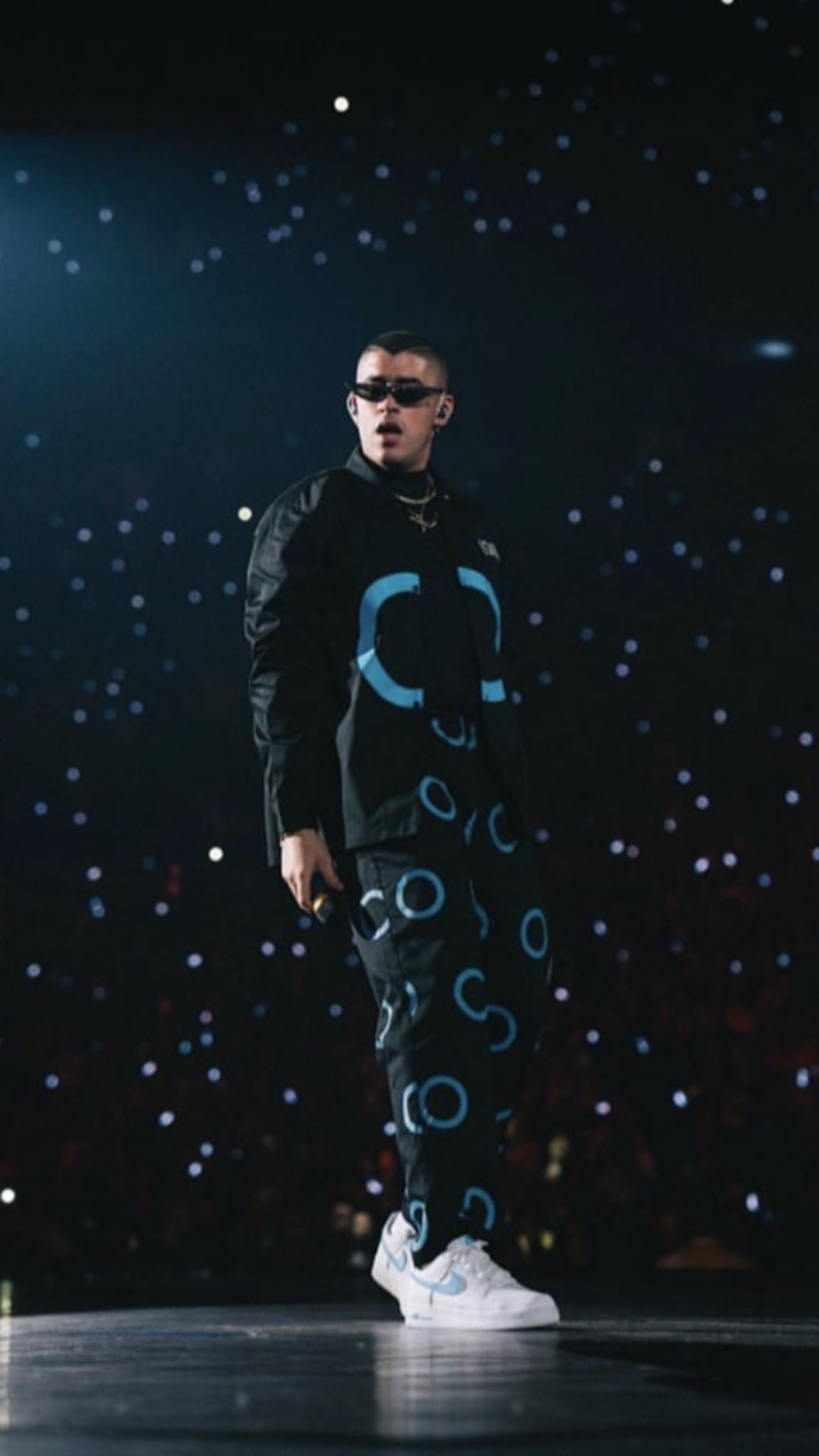 Araffe wearing a black jacket and blue pants on a stage (bad bunny, el conejo malo)