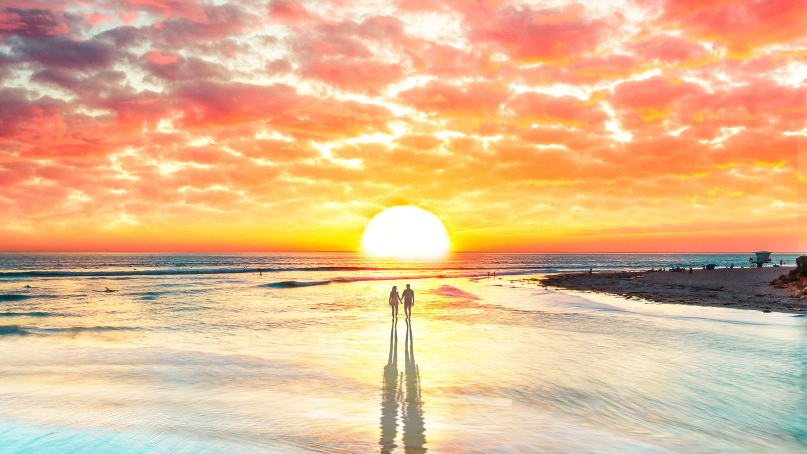 A couple of people standing on a beach next to the ocean (nature, ocean, sunset, sea, horizon)