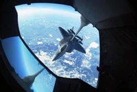 Refueling Operation: Lockheed Martin F-22 Raptor and McDonnell Douglas KC-10 Extender in Flight