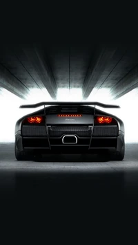 Sleek Black Lamborghini Under Dim Lighting