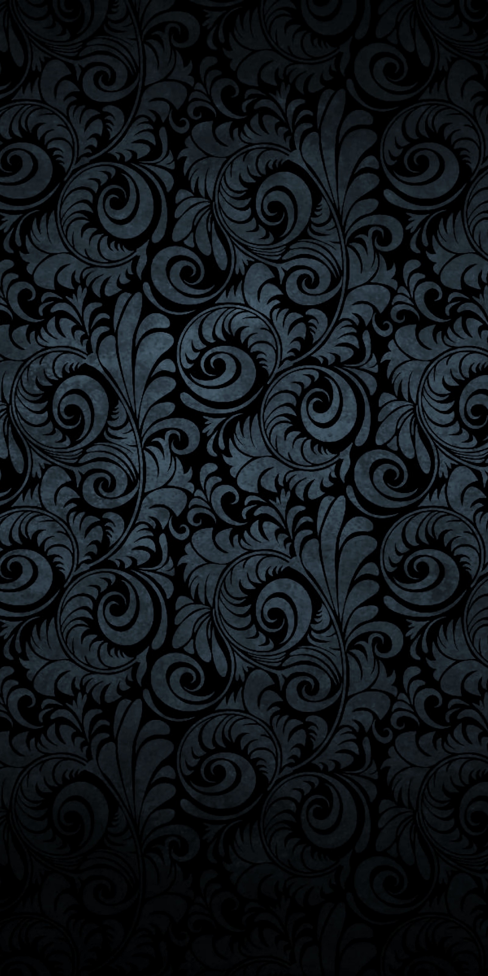 A close up of a black and blue wallpaper with swirly designs (black, dark, flowers)